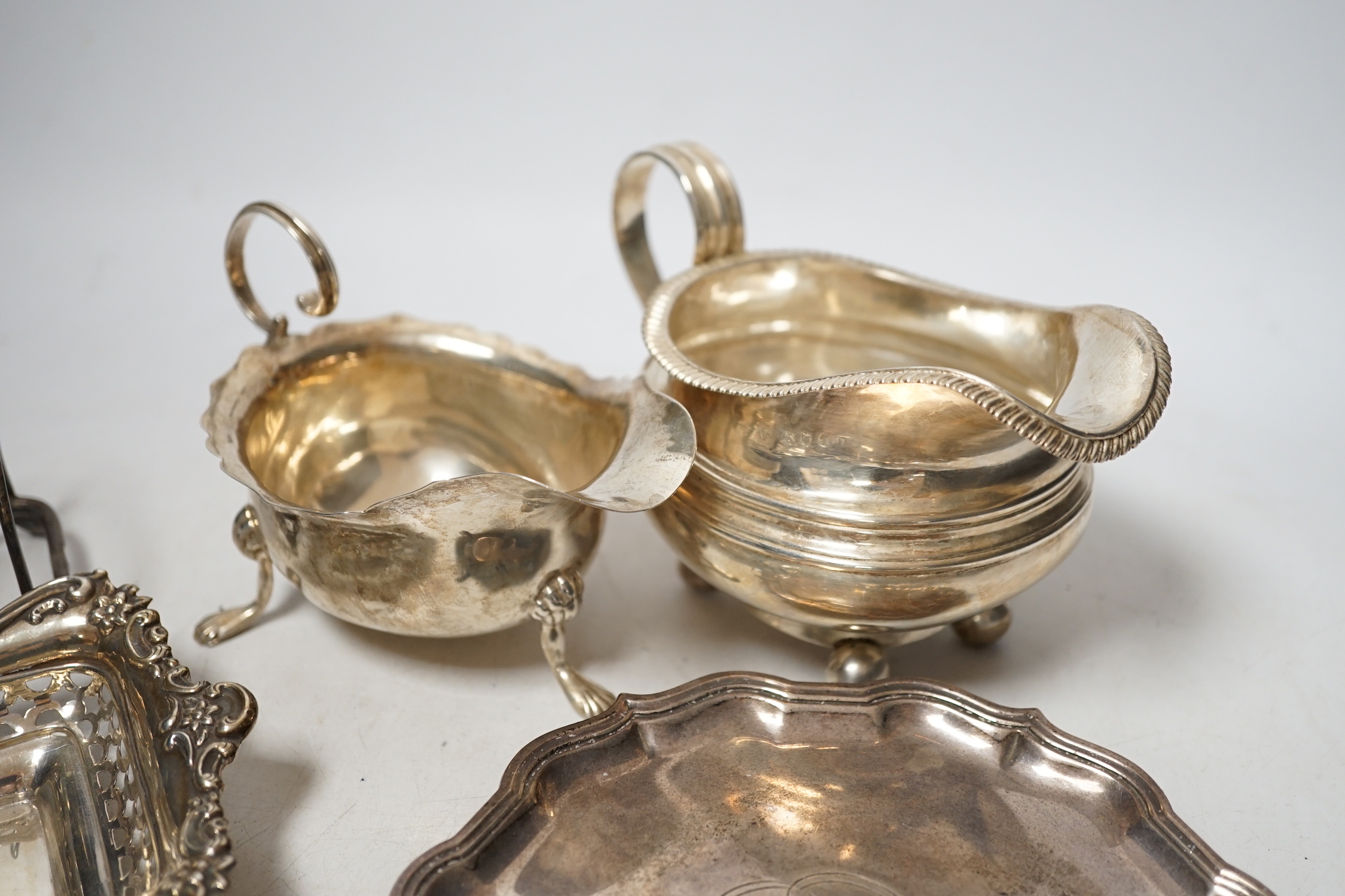 Sundry silver items including a Georgian cream jug, pair of later pierced bonbon dishes, Georgian teapot stand (a.f.), waiter, sauce boat and toastrack, 20.8oz.